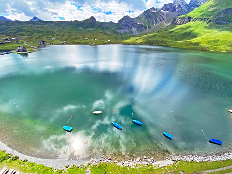 Boats on the artificial alpine lake Melchsee or Melch lake in the Uri Alps mountain massif, Melchtal - Canton of Obwalden, Switzerland (Kanton Obwald, Schweiz)