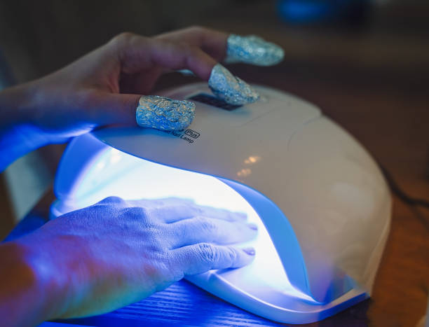 istock UV lamp gel polish manicure process. Salon procedure 1293044923