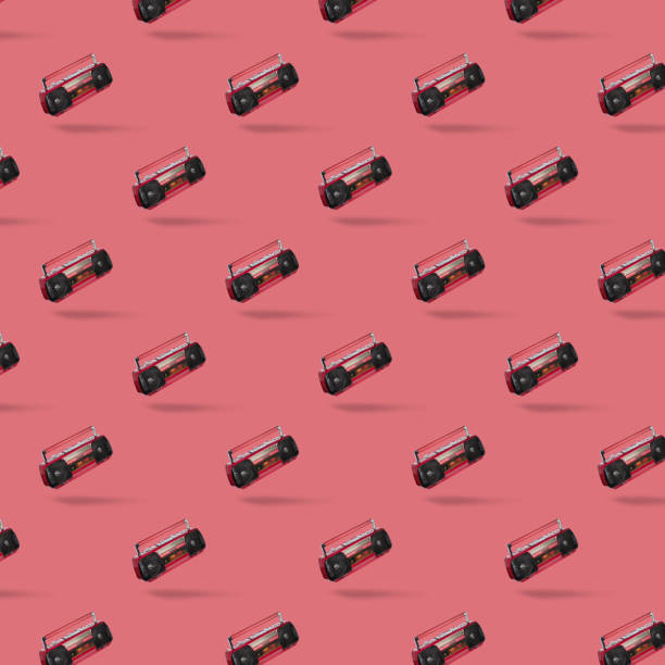 istock Seamless pattern with Vintage radio cassette recorder isolated over pink background.  retro technology 1293046629