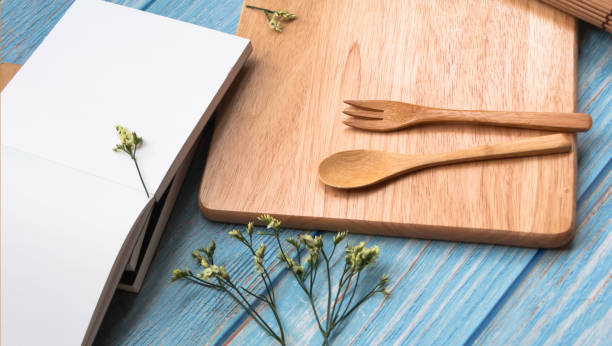 istock Wooden fork and spoon put  on timber board beside beautiful small flower 1293049557