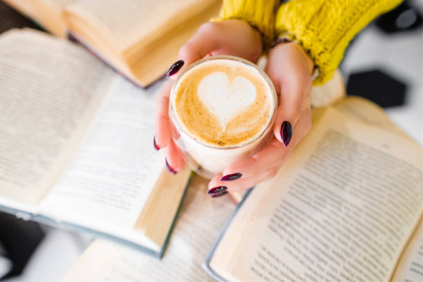 Morning coffee with a pattern on the background of books.