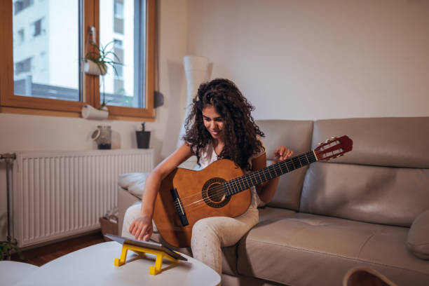 istock Girl learning online how to play guitar 1293058628