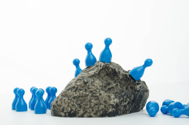 Group of figures plunges down a mountain - lemmings