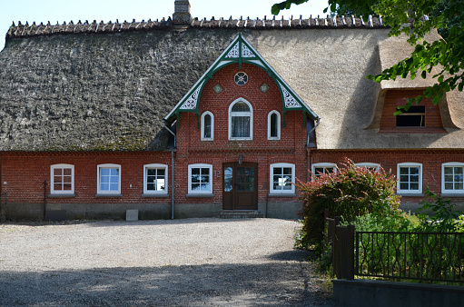 Gluecksburg, Germany, June 23, 2014 - Old reed-roofed farmhouse near Glueckburg near the Baltic Sea