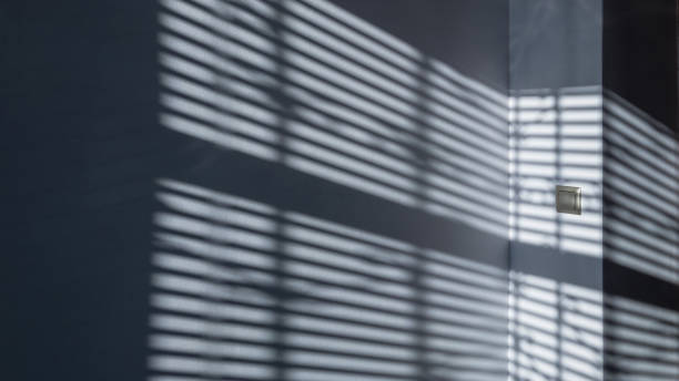 istock Lights shadows. Abstract light, black shadow overlay from window on white texture wall. Sunlight architecture background. Textures Light reflection from the window. 1293068136
