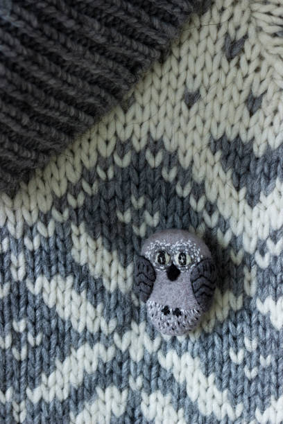 istock Handmade wool brooch on a sweater background. Selective focus. 1293068327
