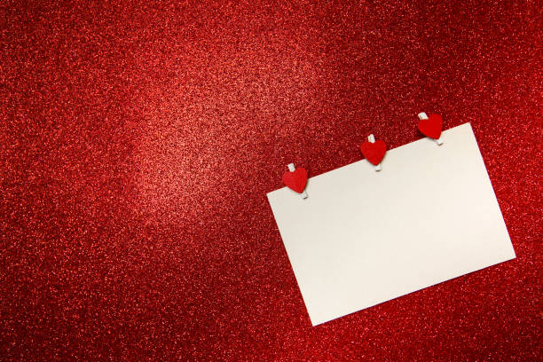 white card with red hearts-clothespins on red background. valentine's day concept - valentine imagens e fotografias de stock