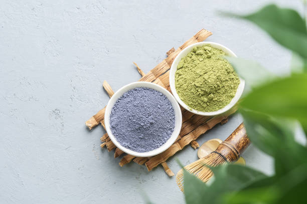 istock Bowls of different matcha tea powder and whisk on a concrete surface. Top view. 1293068887
