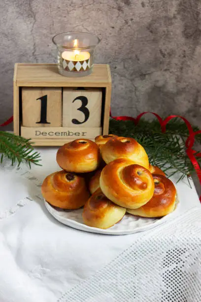 Photo of Traditional Swedish saffron buns of various shapes on a light background.