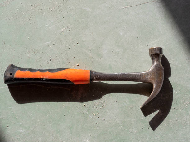 istock construction hammer on drywall. the view from the top, hard shadows. Tools for the job 1293069096