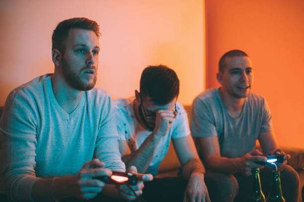 istock Young friends playing video games at home 1293070298