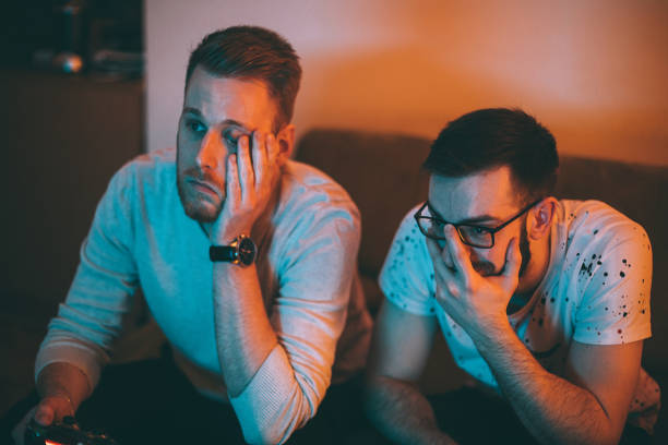 istock Young male friends playing video games and having fun 1293070854
