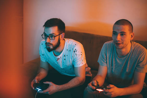 istock Two male friends playing video games and having fun 1293070965