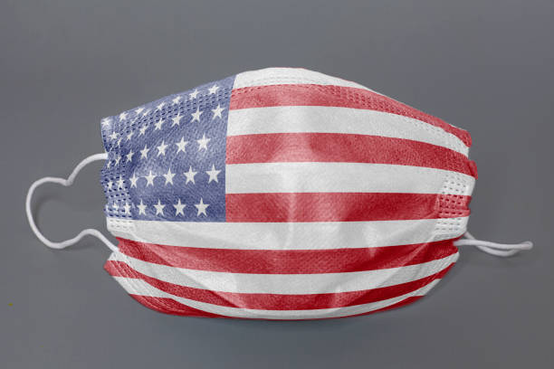 istock Medical protective mask with USA flag on grey background 1293073563