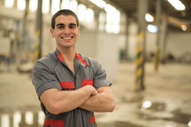 Posing smiling and latin man in concrete factory. Cordoba, Spain. stock photo