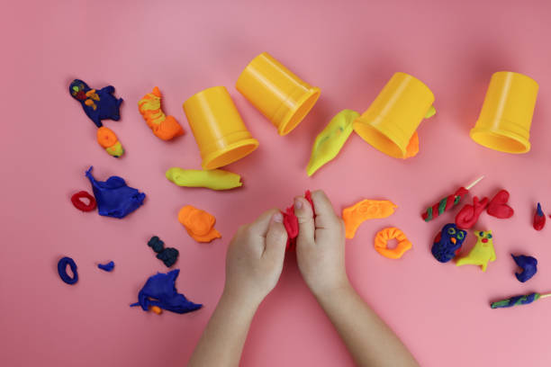 istock Child moulding from colored clay on the table 1293074386