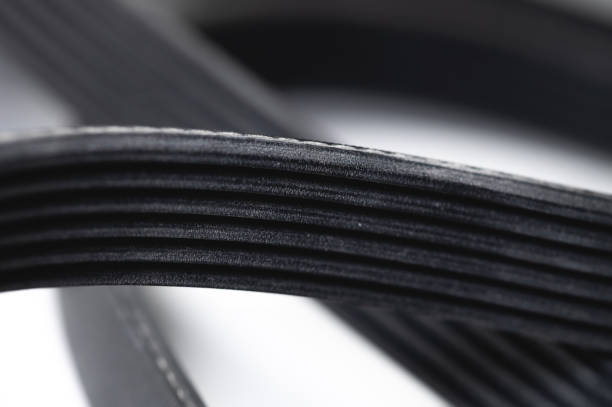 New rubber drive belt for internal combustion engine attachments. Alternator poly-V belt. Close-up.