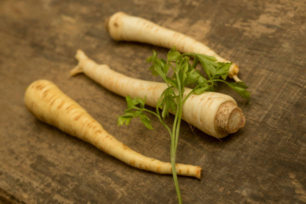 istock Parsnip root vegetable on wooden plank 1293079403