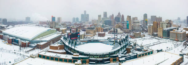 An aerial view of the skyline of the city of Detroit, MI in winter while snowing including Comerica Park and Ford Field An aerial view of the city skyline of Detroit, Michigan on Christmas Day 2020 while it snows including Comerica Park and Ford Field comerica park photos stock pictures, royalty-free photos & images