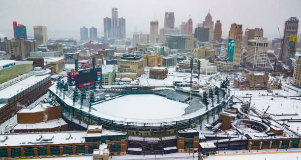 An aerial view of the skyline of the city of Detroit, MI in winter while snowing including Comerica Park An aerial view of the city skyline of Detroit, Michigan on Christmas Day 2020 while it snows including Comerica Park comerica park photos stock pictures, royalty-free photos & images