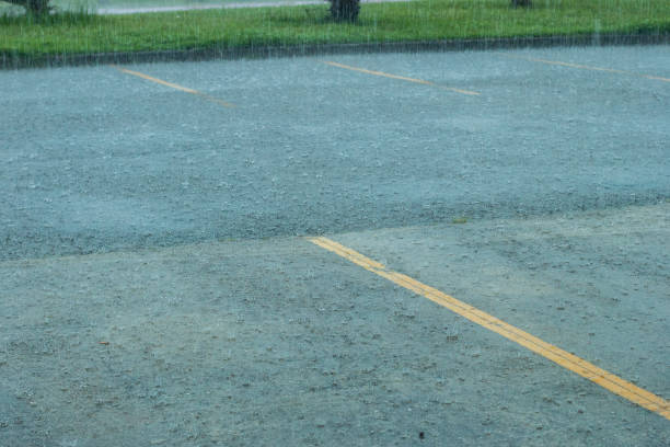 istock rain falling on the asphalt with yellow lines on the ground 1293081487