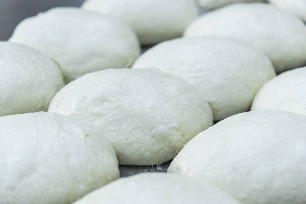istock Shaped dough for craft bread on the table. Making craft bread at the bakery 1293082274