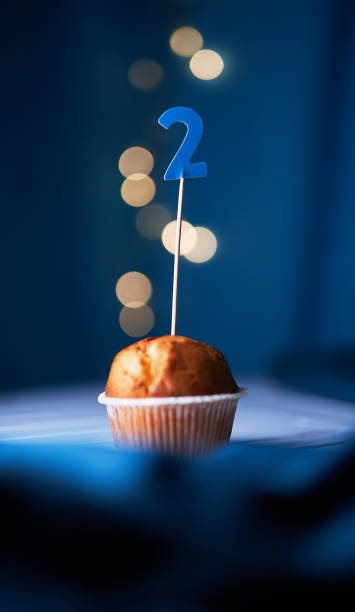 istock Birthday cake with number two (2) and lights on background 1293082541