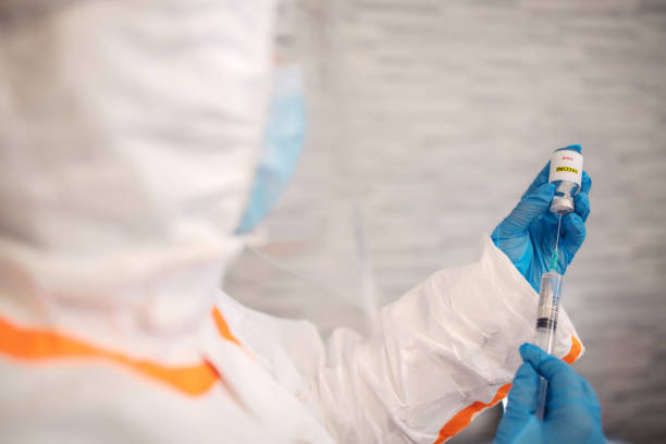 istock Doctor in protective suit work on vaccine against covid19 virus 1293084990