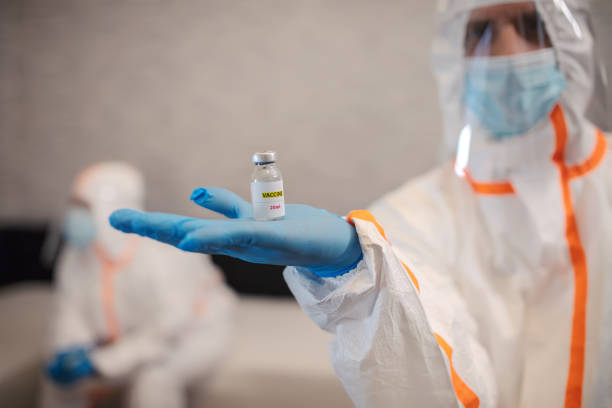 istock Coronavirus covid 19 disease experts hold samples of coronavirus covid 19 vaccine 1293085018