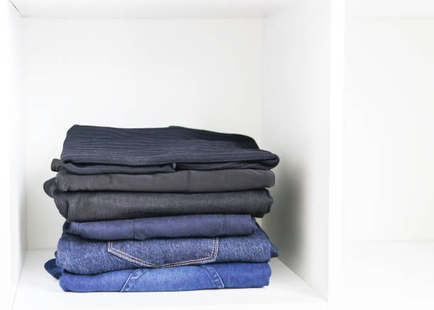 istock Home wardrobe with different clothes. Small space organization. The contrast of order and disorder. 1293086413