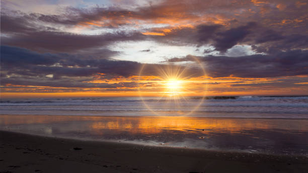 Golden sunrise across the ocean on a beach
