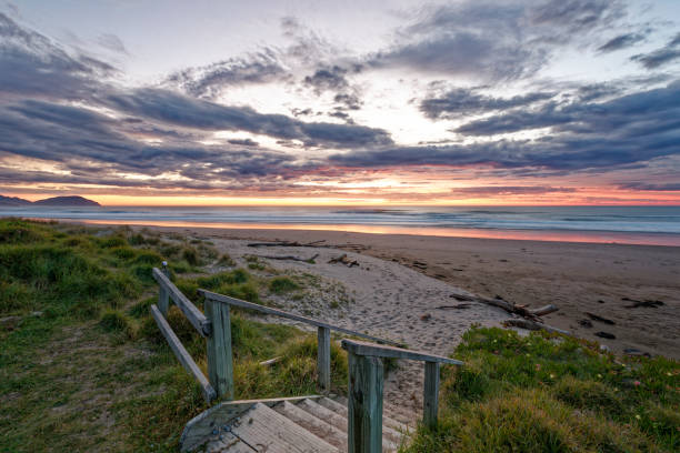 istock Golden sunrise across the ocean on a beach 1293090363
