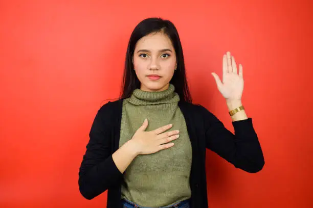 Photo of of Young beautiful asian women using black sweater with red isolated background