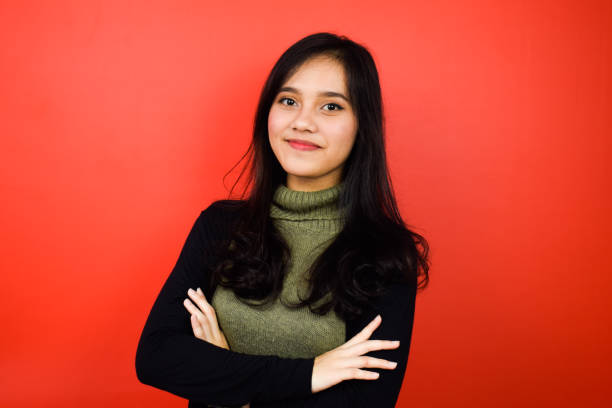 istock Young beautiful asian women using black sweater with red isolated background 1293098662