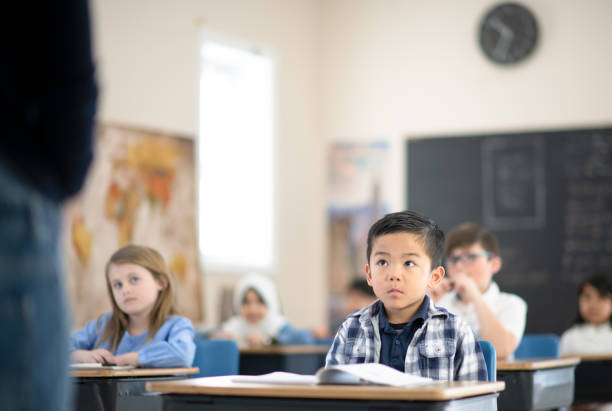 istock Students Listening to Their Teacher Speak 1293099555