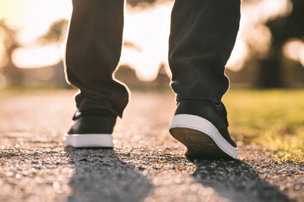 istock Close up of walking man. Walking outdoors. Closeup on shoe, taking a step 1293103664