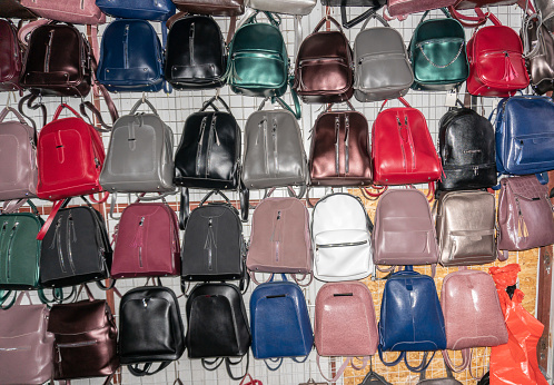 Colorful bags hang on the wall in the market pavilion. High quality photo