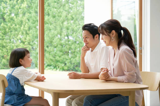 istock Asian family talking at home 1293109020