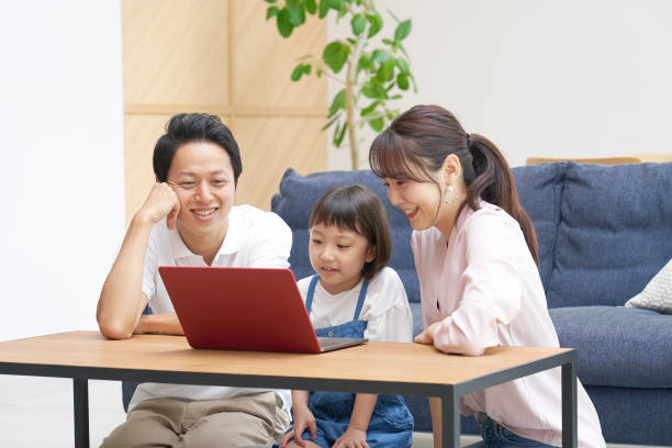 istock Asian family using the laptop at home 1293109333
