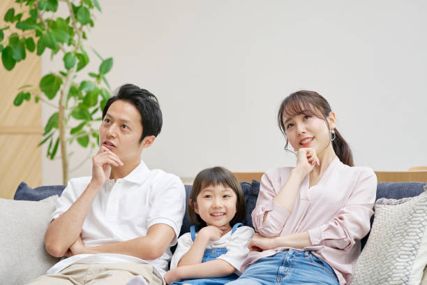 istock Asian family thinking at home 1293109346