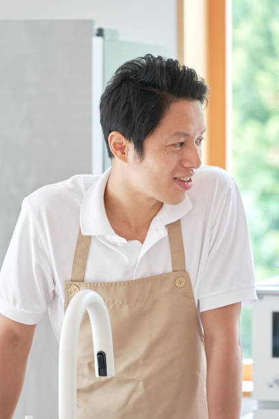 istock Asian man cooking at home 1293109577