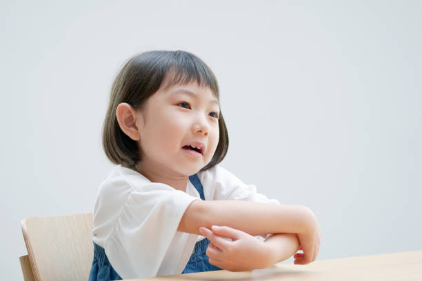 Asian girl feeling itchy on the chair Asian girl feeling itchy on the chair elementary student pointing stock pictures, royalty-free photos & images