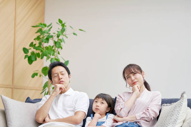 istock Asian family thinking at home 1293109602