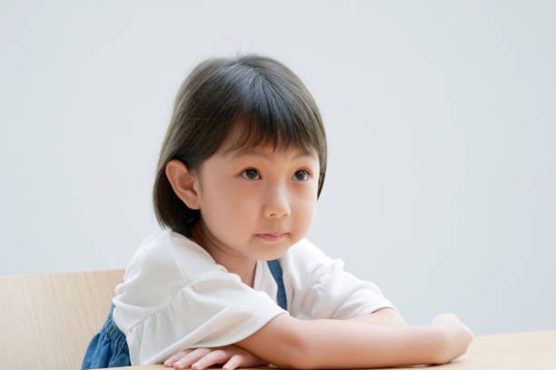 istock Asian girl thinking on the chair 1293109614