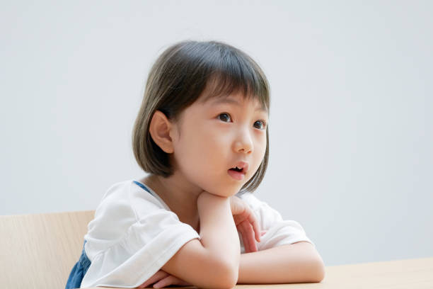 istock Asian girl thinking on the chair 1293109623