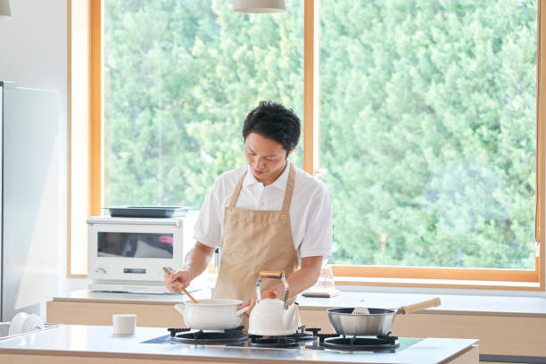Asian man cooking at home