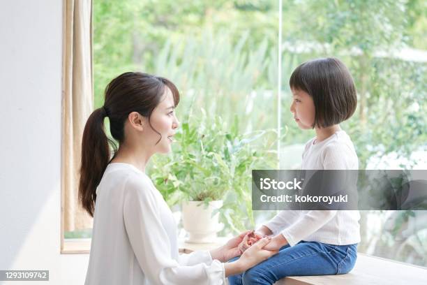 Asian Mother Talking With The Daughter Stock Photo - Download Image Now - Child, Talking, Parent