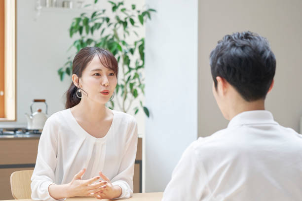 Asian couple talking at home