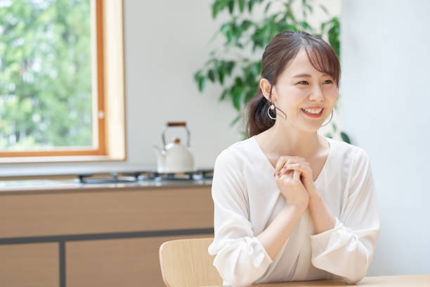 istock Asian woman smiling at home 1293109758