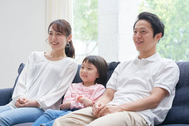 istock Asian family smiling on the sofa 1293109790